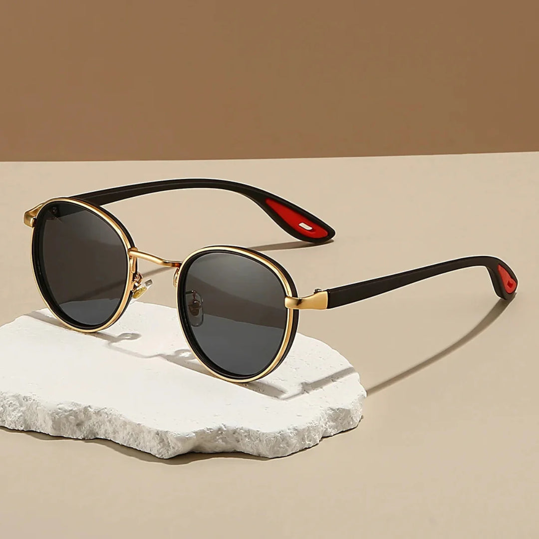 Alton Round Frame Sunglasses with lightweight metal frames and gradient UV400 lenses on a stylish display.